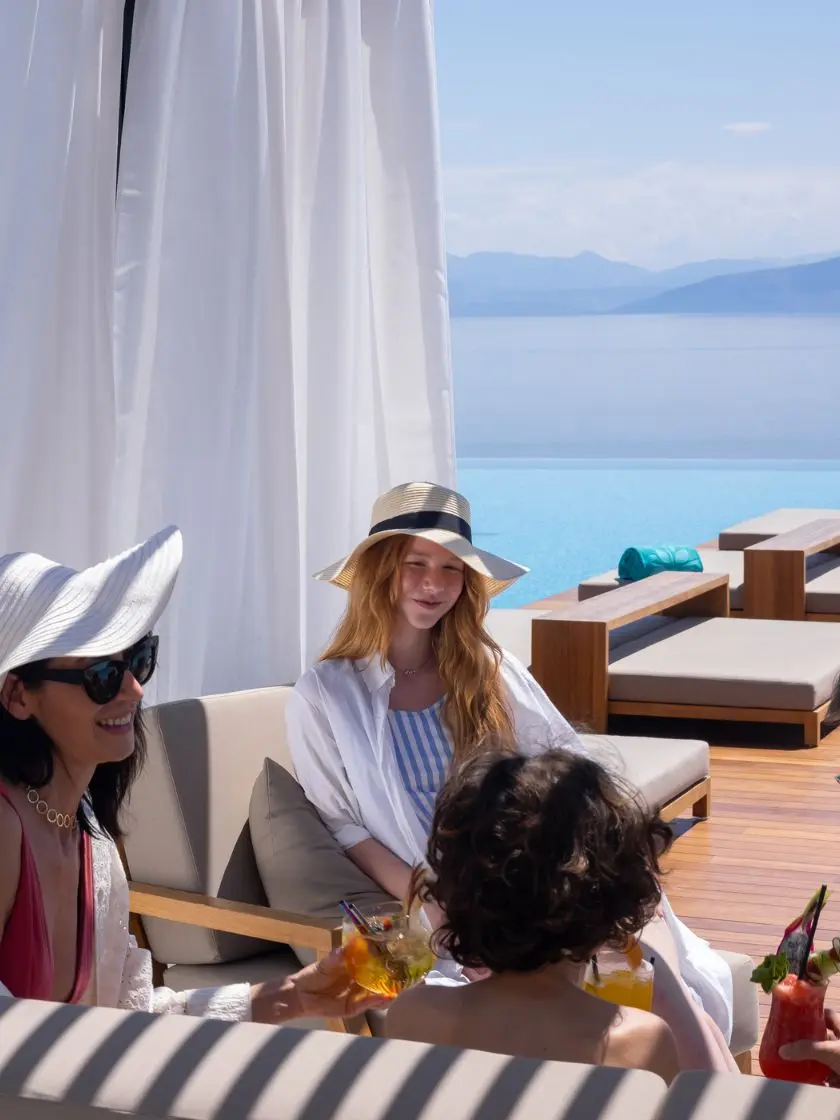 Family enjoying fresh juice by the infinity pool