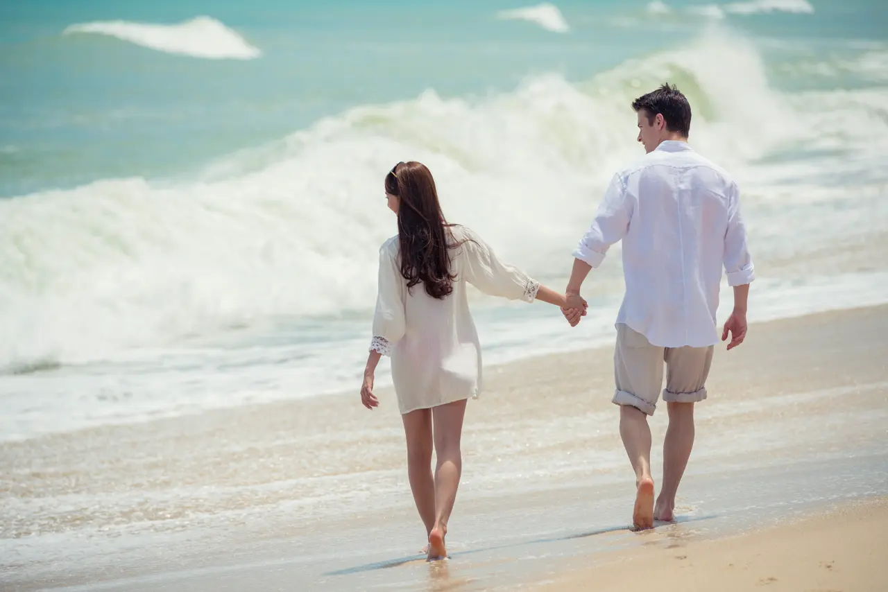 Couple walking on Angsana Laguna Phuket Beach